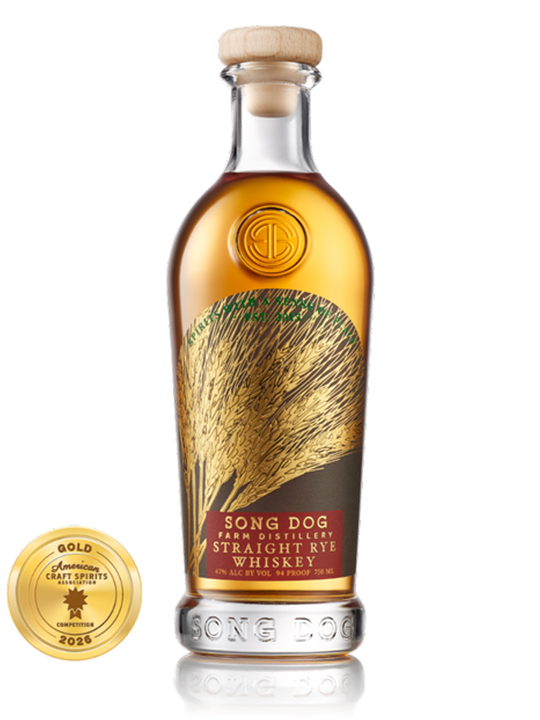 A bottle of Song Dog Farm Distillery Straight Rye Whiskey with a gold seal for a 2026 Craft Spirits Award. The label, reminiscent of the artistry seen in Baltimore Spirits Company releases, features an illustration of rye stalks.